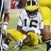 Michigan senior quarterback Denard Robinson holds his arm after an injury during a play in the second quarter against Nebraska at Memorial Stadium in Lincoln, Nebraska on Saturday. Melanie Maxwell I AnnArbor.com